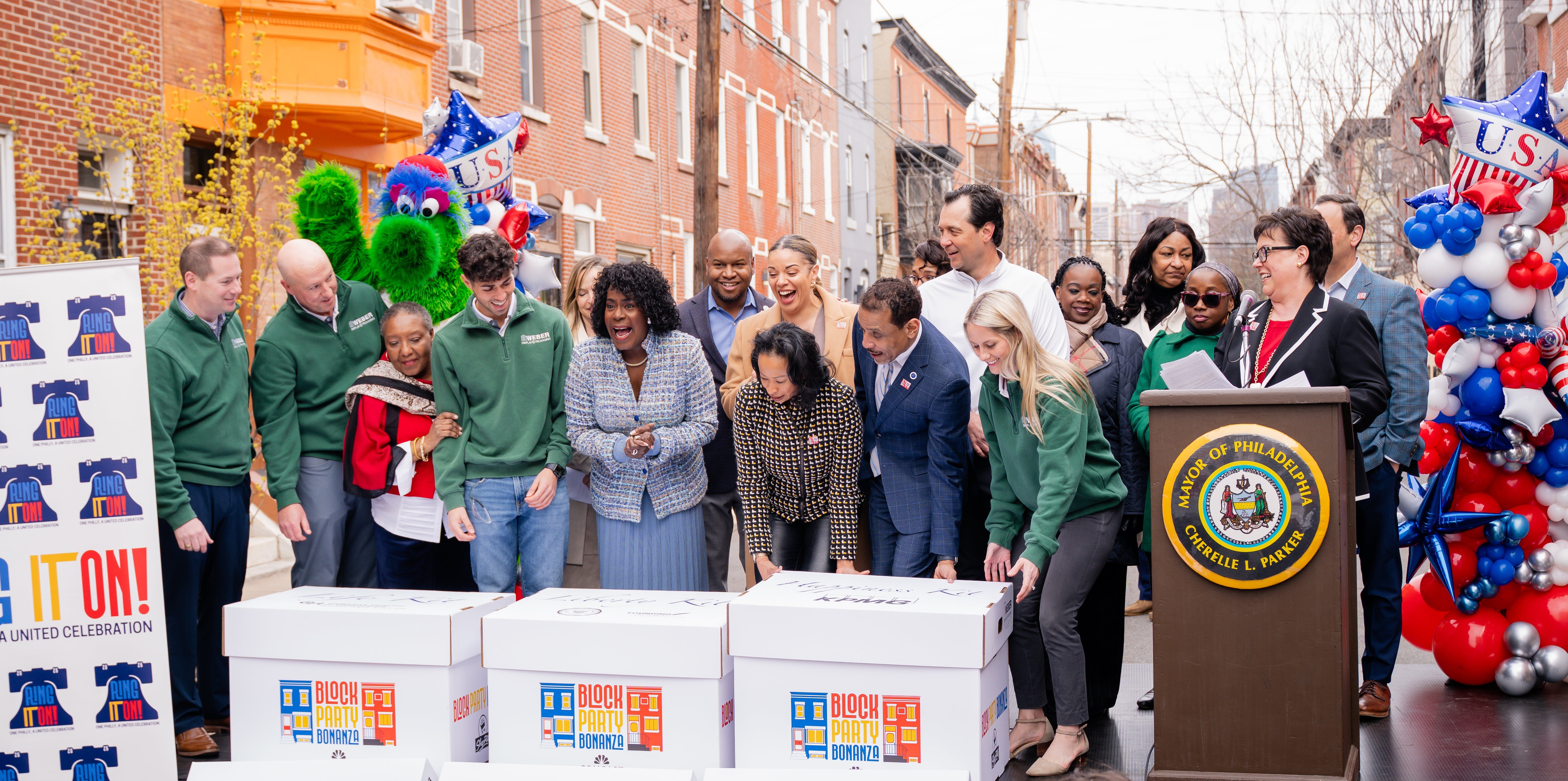 officials on stage revealing block party bonanza kits