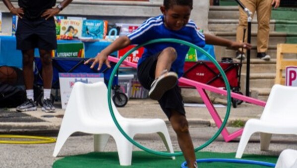 child playing with hula hoop