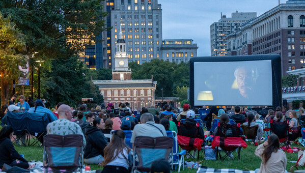People watching a movie in front of Independence Hall.