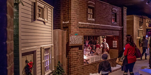 Visitors looking at a display in Dickens Village