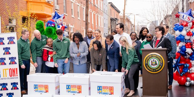 officials on stage revealing block party bonanza kits