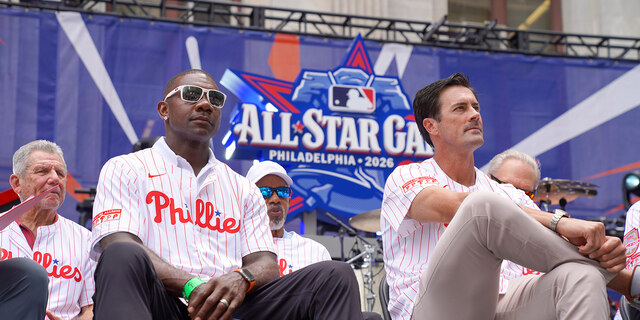 Phillies players sitting on stage with "All Star Game" sign in the background. 