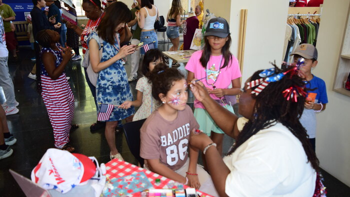 Child receiving patriotic face paint
